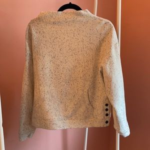 Cream colored pullover.